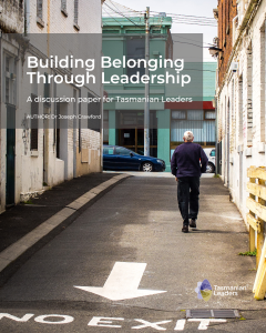 photo of a man walking up a laneway with his back towards the viewer