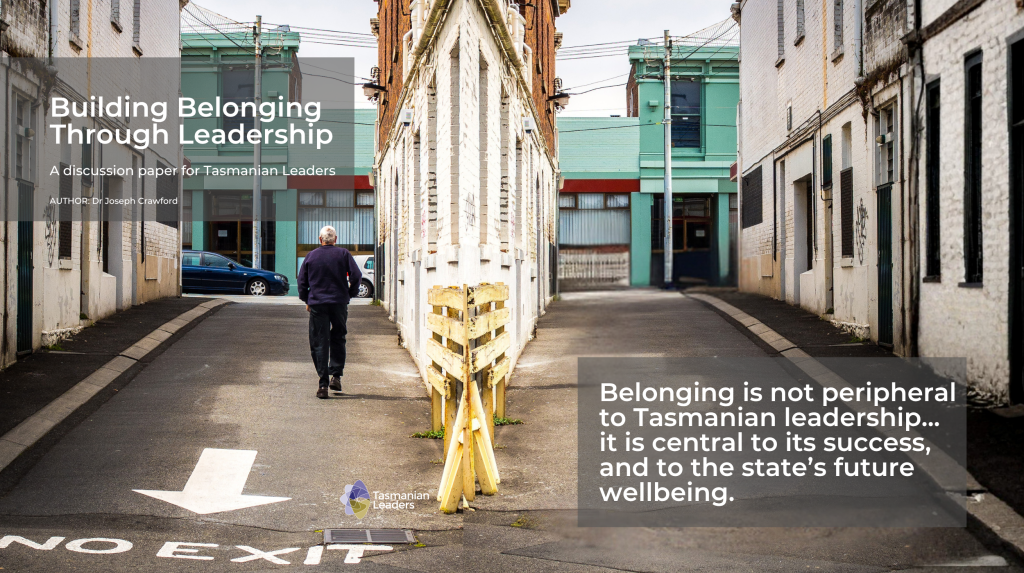 Image of a man walking up a laneway with his back to us, text reads Building belonging through leadership a discussion paper for Tasmanian leaders, Author Dr Joseph Crawford.